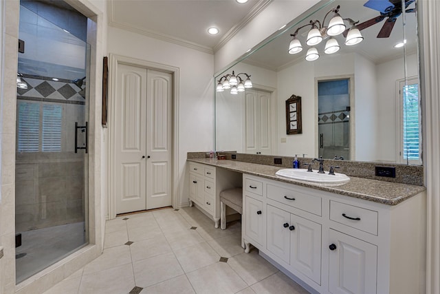 bathroom featuring ornamental molding, ceiling fan, a shower stall, vanity, and tile patterned floors