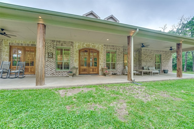 back of property featuring french doors, brick siding, and ceiling fan