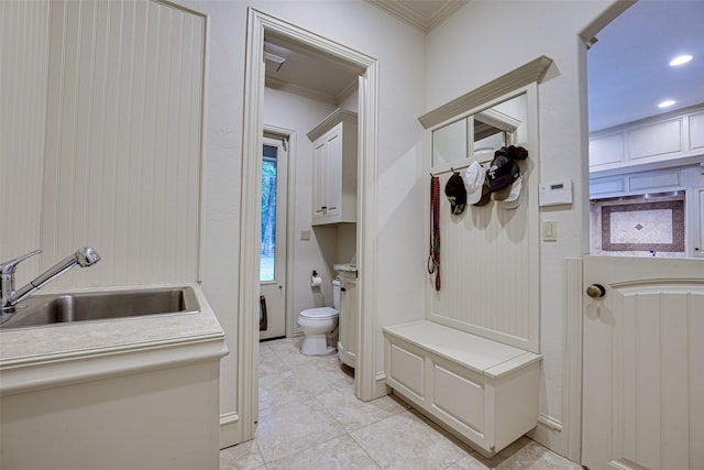 mudroom featuring crown molding, recessed lighting, a sink, and light tile patterned floors