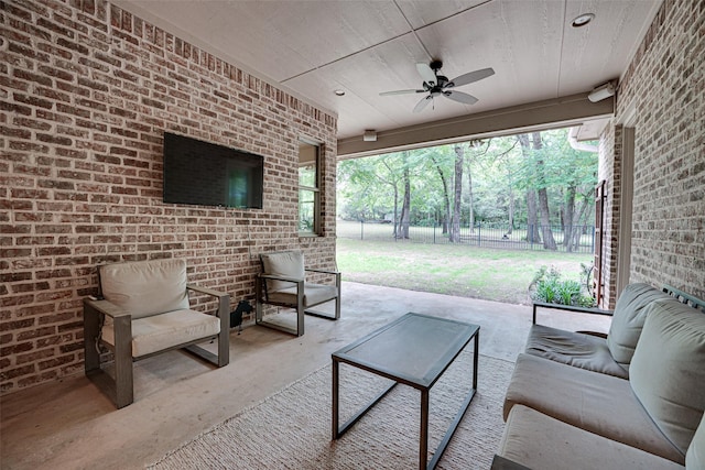 view of patio / terrace featuring fence, an outdoor living space, and a ceiling fan