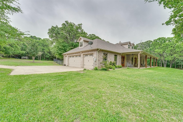 view of side of home featuring roof with shingles, brick siding, a lawn, an attached garage, and driveway