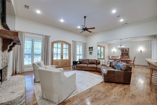 living room featuring light wood-style floors, visible vents, and plenty of natural light