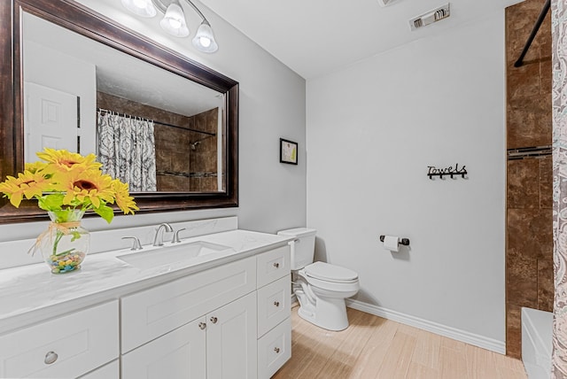 full bathroom with toilet, baseboards, visible vents, and tiled shower