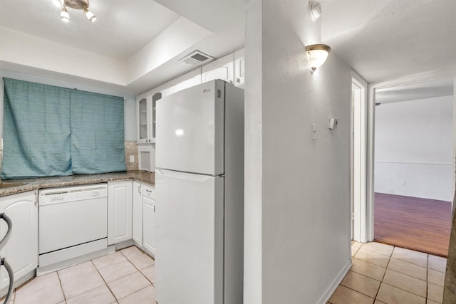 kitchen featuring white cabinets, white appliances, visible vents, and light tile patterned floors