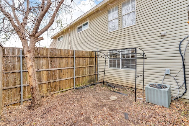 view of yard featuring fence and central air condition unit