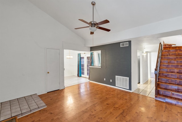 spare room with light wood-style flooring, french doors, visible vents, and stairway