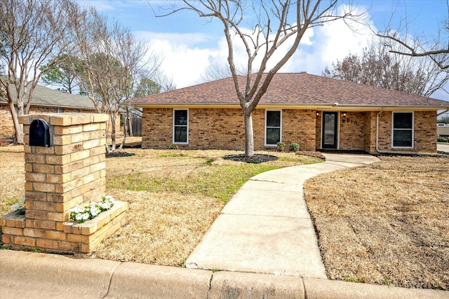 ranch-style house with brick siding and a shingled roof