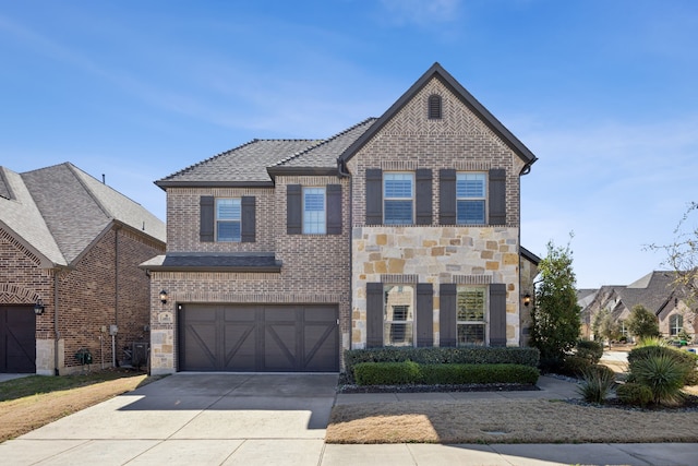 view of front of house featuring stone siding, concrete driveway, brick siding, and a garage