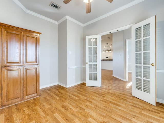 unfurnished room featuring visible vents, crown molding, light wood-style flooring, and baseboards