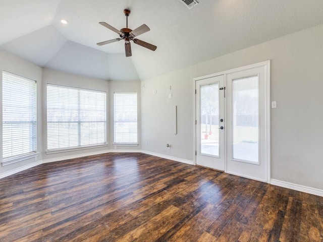 spare room with a healthy amount of sunlight, vaulted ceiling, and wood finished floors