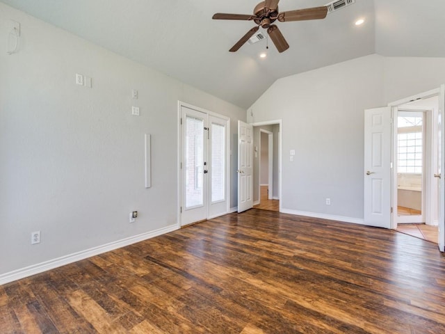 spare room with lofted ceiling, wood finished floors, and a healthy amount of sunlight