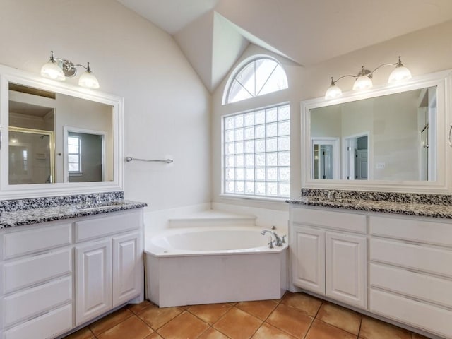 bathroom with a healthy amount of sunlight, a stall shower, vaulted ceiling, and tile patterned floors