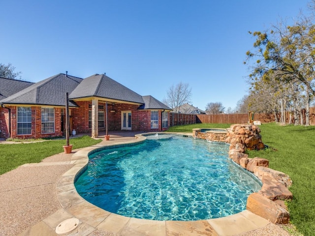 view of swimming pool with a patio, a fenced backyard, a pool with connected hot tub, a yard, and french doors