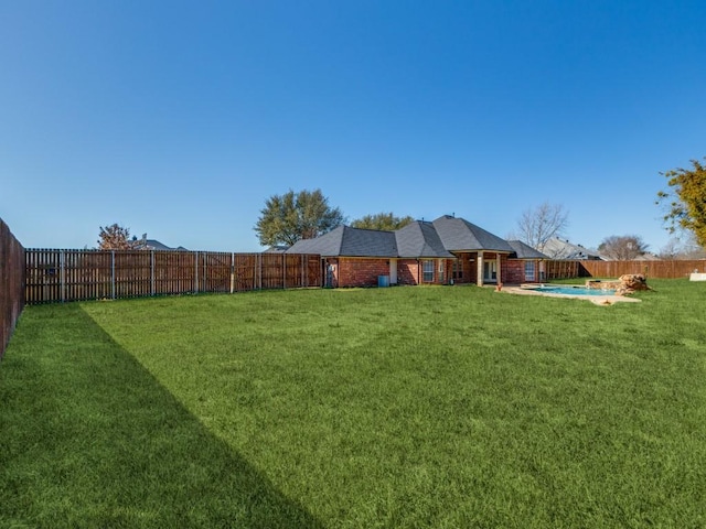 view of yard with a fenced in pool and a fenced backyard