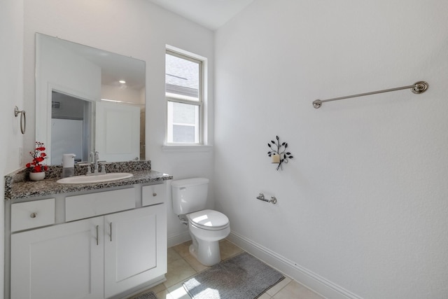 bathroom with toilet, tile patterned flooring, baseboards, and vanity