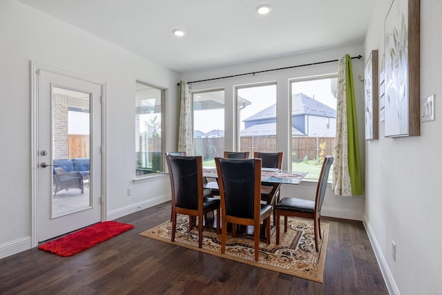 dining area featuring a healthy amount of sunlight, baseboards, wood finished floors, and recessed lighting