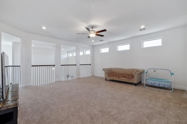 sitting room with carpet floors, recessed lighting, and baseboards