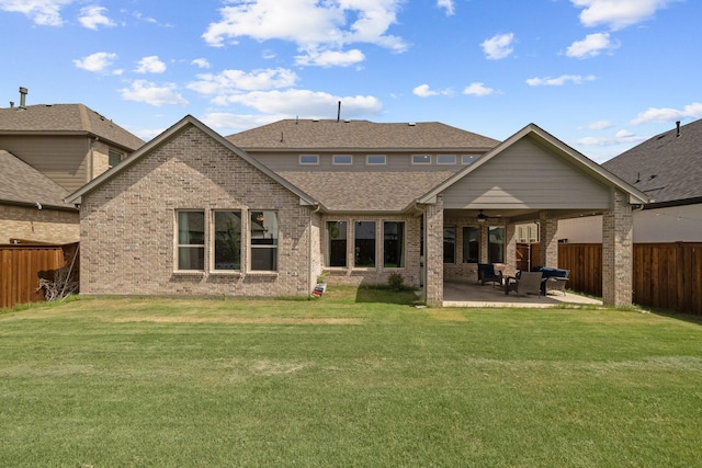 back of house featuring a patio area, a fenced backyard, a ceiling fan, and a yard