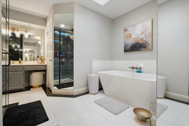 full bath featuring tile patterned flooring, a freestanding tub, a shower stall, and vanity