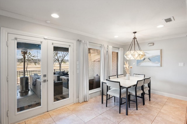 dining space with light tile patterned floors, visible vents, baseboards, crown molding, and french doors