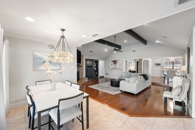 dining room with a ceiling fan, visible vents, lofted ceiling with beams, and light tile patterned floors