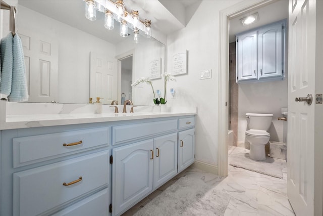 bathroom with marble finish floor, vanity, toilet, and baseboards