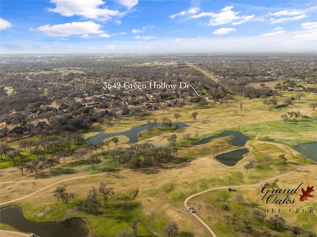 drone / aerial view featuring view of golf course and a water view