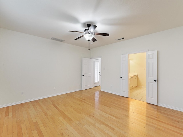 unfurnished bedroom featuring baseboards, visible vents, and light wood-style floors