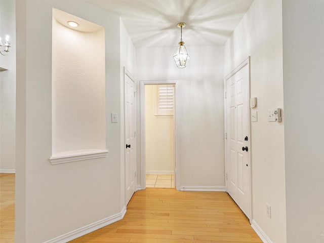 foyer entrance featuring light wood-style flooring and baseboards