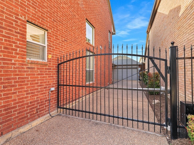 view of gate featuring an outdoor structure