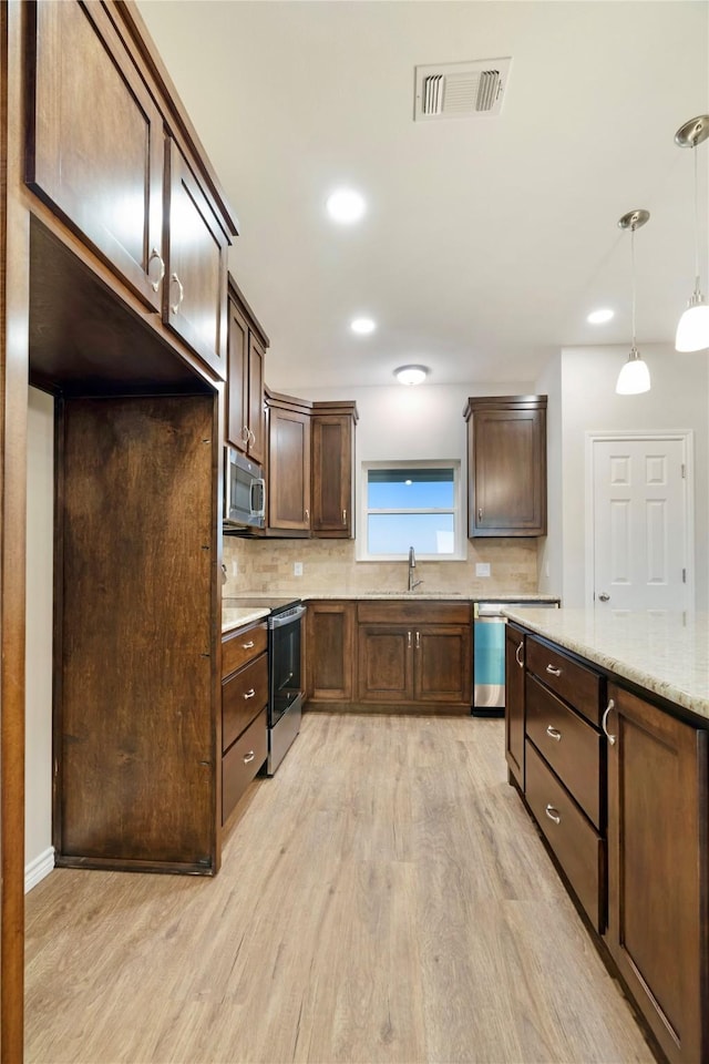 kitchen featuring visible vents, backsplash, appliances with stainless steel finishes, dark brown cabinets, and light wood-type flooring