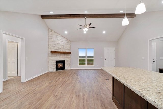 unfurnished living room featuring light wood-type flooring, baseboards, and beamed ceiling