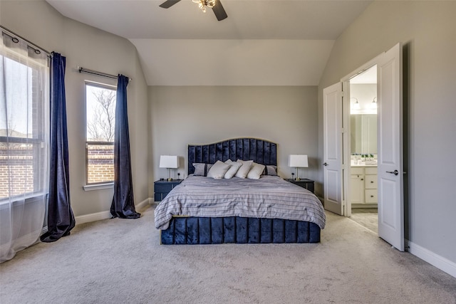 bedroom with ensuite bath, carpet, and vaulted ceiling