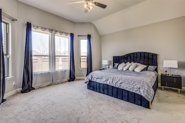 carpeted bedroom with ceiling fan, baseboards, and vaulted ceiling