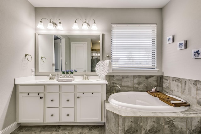 full bathroom featuring double vanity, a sink, and a bath