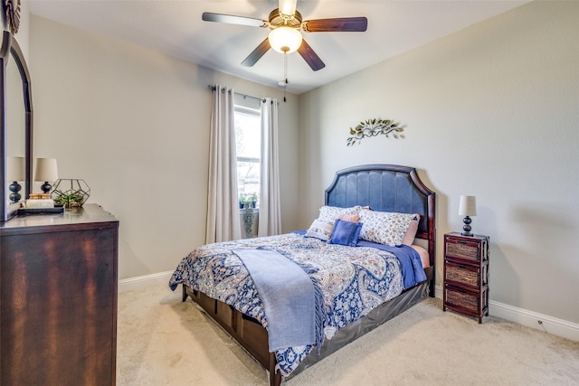 carpeted bedroom with a ceiling fan and baseboards