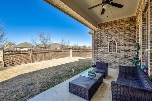 view of patio / terrace with a fenced backyard, an outdoor living space, and a ceiling fan