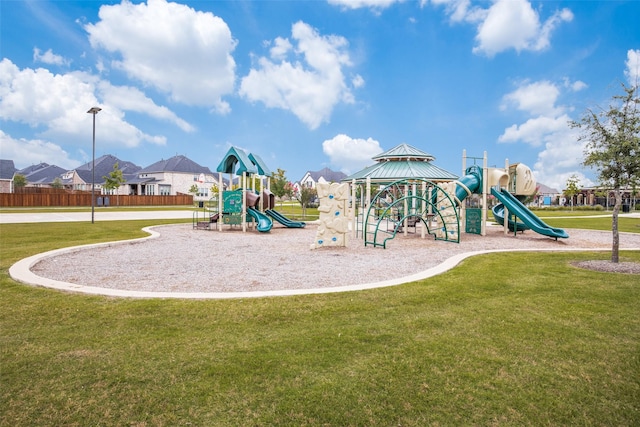 community jungle gym featuring a lawn