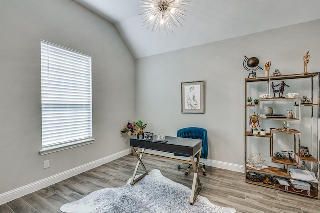 office space featuring a chandelier, vaulted ceiling, baseboards, and wood finished floors