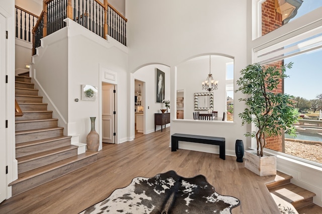 1503 Kingswood Ln, Colleyville, TX 76034 - entryway featuring a towering ceiling, plenty of natural light, arched walkways, stairs, and wood finished floors