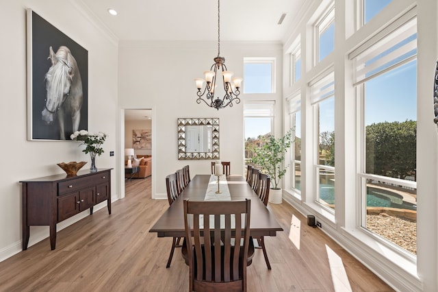 1503 Kingswood Ln, Colleyville, TX 76034 - dining space with healthy amount of natural light, crown molding, wood finished floors, a towering ceiling, and a chandelier