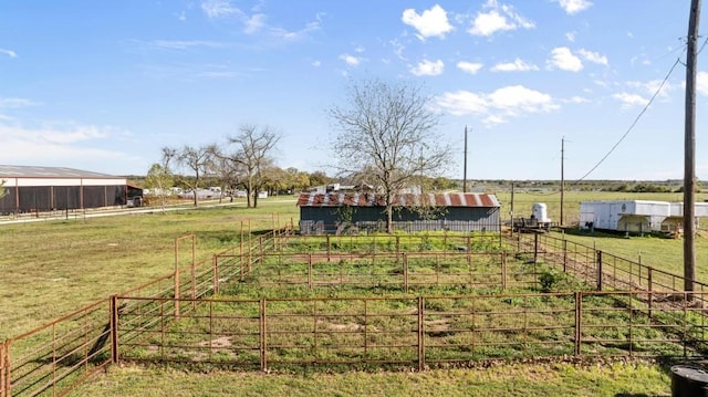 view of yard with an outbuilding and a rural view