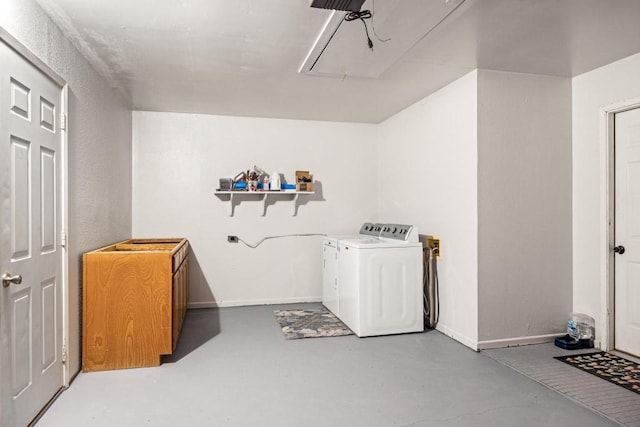 washroom with washer and dryer, laundry area, attic access, and baseboards