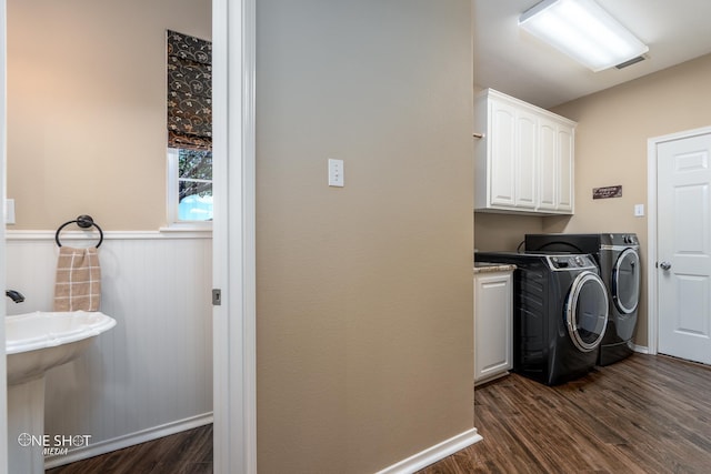 laundry area with dark wood-style flooring, cabinet space, visible vents, and separate washer and dryer