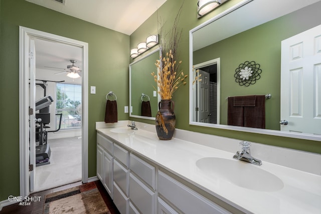 full bathroom featuring double vanity, a sink, and a ceiling fan