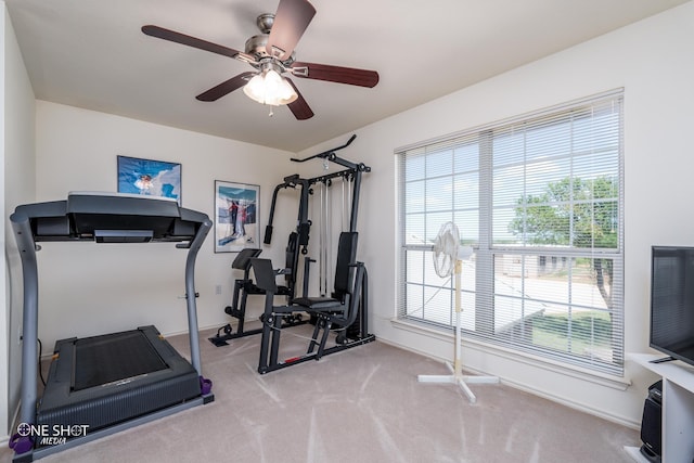 workout area featuring carpet floors, a ceiling fan, and baseboards