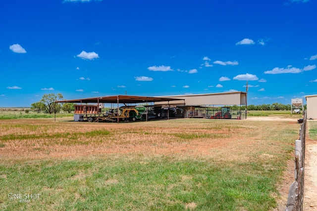 rear view of house featuring a carport and an outdoor structure