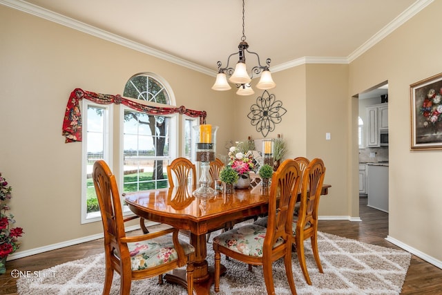 dining room featuring ornamental molding, wood finished floors, and baseboards