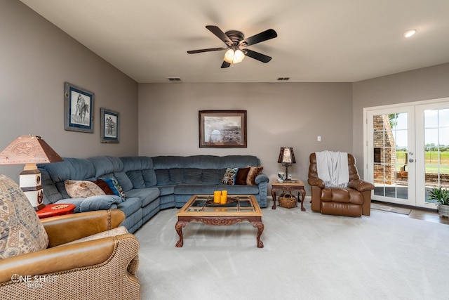 living room with carpet, visible vents, a ceiling fan, and french doors