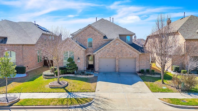 traditional home with an attached garage, brick siding, driveway, and a front lawn